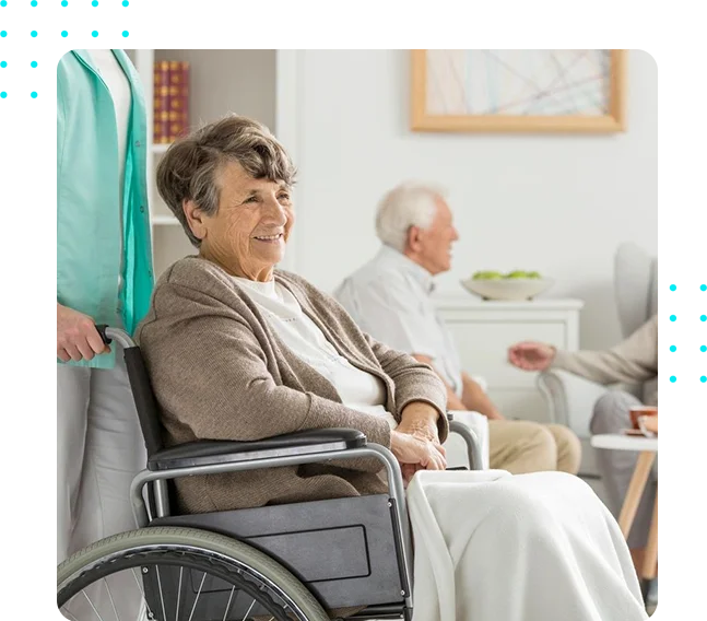 A woman in a wheelchair with other people sitting around.