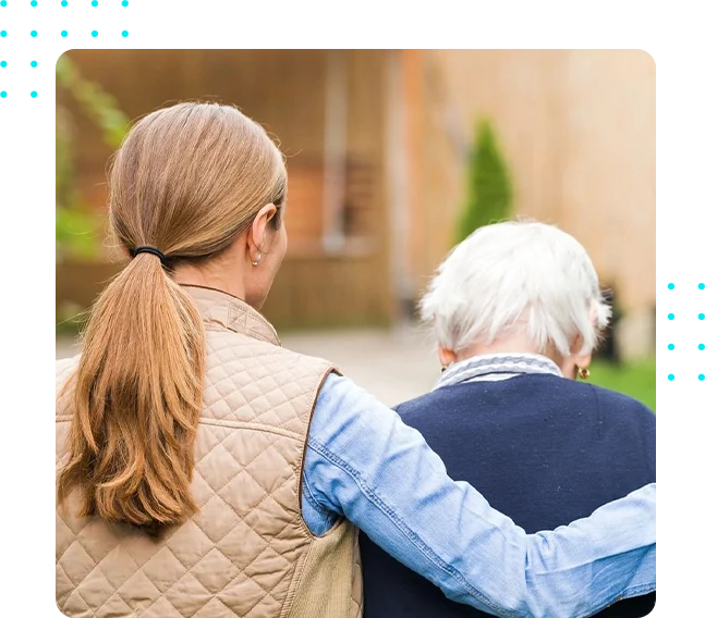 A woman and an elderly person are walking.