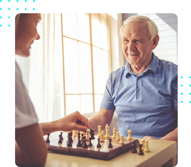 A woman and an old man playing chess