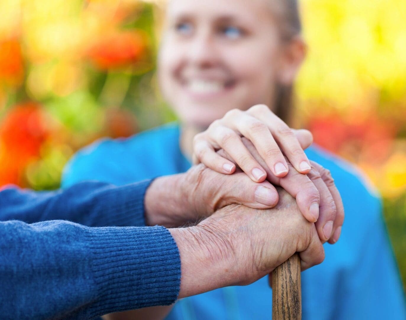 A woman holding hands with another person on top of her arm.